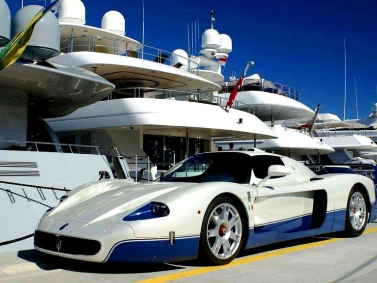 White sports car with black details, parked on a racetrack.